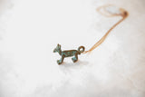 The unique profile and blue patina of a vintage handmade fox pendant.