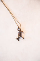 Textured vintage handmade African fox pendant with dark bronze patina.