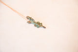 Angled view of the vintage crocodile pendant highlights its textured, oxidized patina.