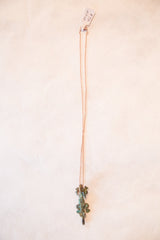 Vintage African crocodile pendant with an oxidized patina hanging from its copper chain.