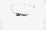Vintage crocodile pendant with a dark bronze patina shown in profile.