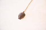 Dark bronze patina and handmade texture on the vintage African face pendant.