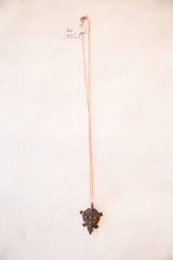 Suspended vintage African dark bronze turtle pendant necklace with handmade texture.