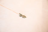 The textured body and blue oxidized patina of a vintage lizard pendant.