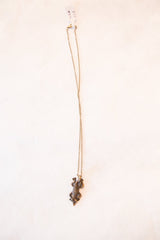 Vintage African lizard necklace shown hanging to display its full length and patina.