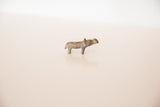 Side profile of a vintage bronze hippo figurine showing its aged patina and texture.