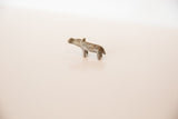 Angled profile of a mini bronze hippo showing its vintage, textured surface.