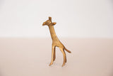 Vintage African golden bronze giraffe legs showing etched patterns and patina.