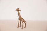 Angled view of a handmade vintage African bronze giraffe with a rustic, aged patina.