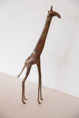 Vintage tall bronze giraffe showing its elegant, slender form and textured finish.