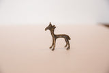 Side profile of the vintage bronze gazelle fawn showing its rustic, handmade texture.