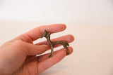 Vintage bronze gazelle sculpture held in hand, showing its small collectible scale.