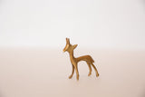 Side profile view of a handmade vintage golden bronze gazelle fawn.