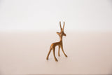 Rear-side view of the vintage bronze gazelle highlighting its graceful, slender form and legs.