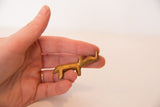 Hand-held vintage African golden bronze rhino, highlighting its handmade patina.