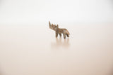 Angled rear view of the miniature tinted bronze rhino sculpture.