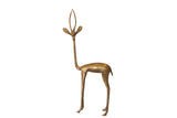 Vintage African golden bronze gazelle sculpture, left-facing, showing handmade charm.