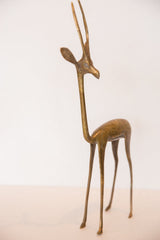 Vintage handmade bronze gazelle sculpture, slender body and elegant golden legs.