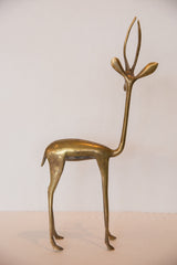 Vintage African bronze gazelle sculpture, left facing, showcasing golden patina.