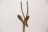 Close-up of the vintage bronze gazelle sculpture's head, showcasing aged patina on its horns.