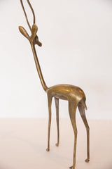 Vintage bronze gazelle sculpture's slender legs, displaying its aged patina.