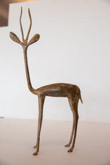 Slender bronze legs and small hooves of the vintage African gazelle sculpture, showing rich patina.