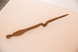 Handmade African iron stake's unique curvature and rich, reddish-brown patina.