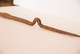 Curved form and rich iron patina on the vintage African stake figure.