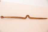 Vintage African handmade iron stake figure displaying rich rust patina and unique bent shape.