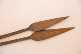 Aged, rust-colored texture on the pointed ends of a vintage iron spear tip.