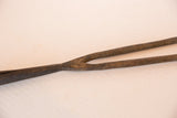 Weathered brown iron texture and split detail of the handmade vintage spear tip.