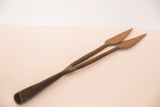 Rusted, aged texture on the two pointed ends of the vintage iron spear tip.