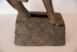 Detail of the vintage copper sculpture's base, showing aged patina and woven design.