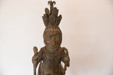 Close-up of the African Copper Man's face, elaborate headdress, and aged patina.