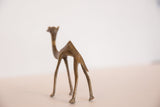 Rear view of a vintage African bronze camel highlighting its slender, stylized form.
