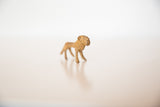 Side profile of a mini bronze lion showing its handmade shape and rusty patina.