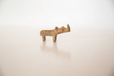 Handmade vintage bronze rhinoceros sculpture with rustic patina and green hues.
