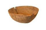 Vintage hand-carved primitive wooden bowl with natural patina and visible split.