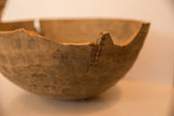 Rough rim with a large vertical split on a vintage African wooden bowl.