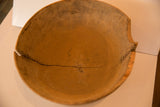 Aged wooden bowl interior with a prominent split and natural patina.