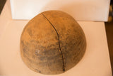 Aged surface of the vintage African wooden bowl, showing the large split with zig-zag fasteners.