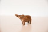 Vintage copper hippo sculpture in a turning pose, displaying rich patina.