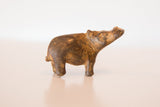 Side profile of a vintage bronze hippo showing its rustic, textured patina.