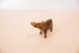 Angled view of a vintage bronze hippo's head showing its textured rusty patina.
