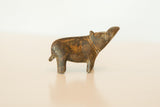 A small vintage bronze hippo sculpture with an aged, dark patina, turning its head.