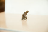 Rear view of the vintage bronze hippo figure with its head turned.