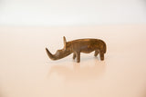 The slender form and dark, aged bronze finish of a vintage rhino sculpture.
