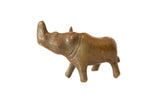 Vintage African bronze rhino figurine turning sideways, showing its handmade texture.