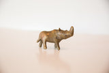 Vintage African bronze rhino sculpture showing the character of its handmade, textured body.