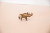 Vintage African bronze rhino sculpture seen in profile, showing its turning head.
